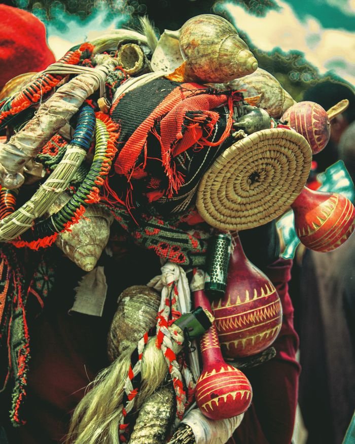 A colorful assortment of traditional handcrafted items, with woven baskets, gourds, and textiles.